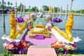 Floating pavilion with golden naga sculpture on the river at wat Rai-Khing Temple.